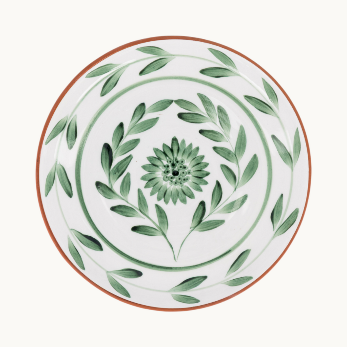 MANTRA LIVING Lebrillo platter in terracotta with a white glazed interior and hand-painted green botanical motifs.