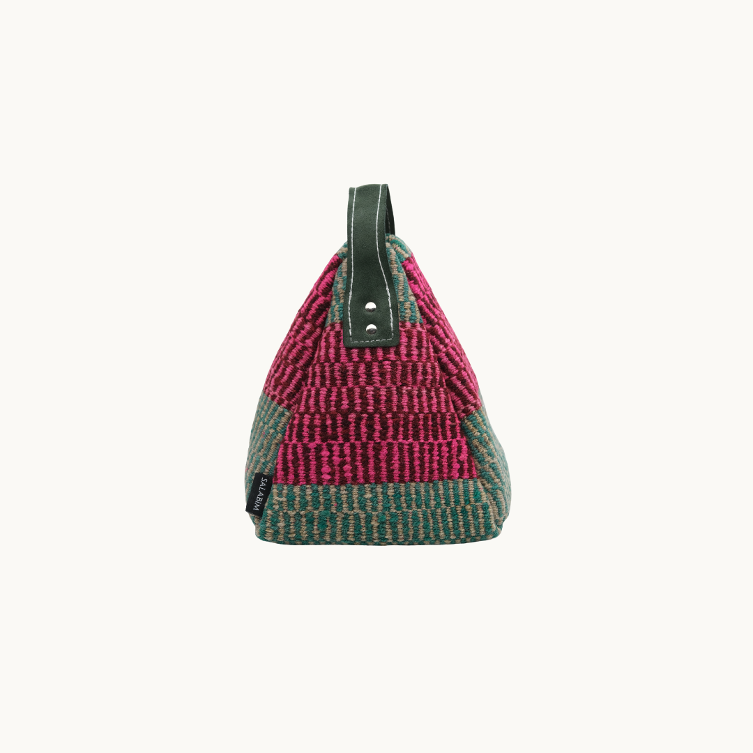 Side profile of the pink and sage Salabim door stop, showing the riveted dark green leather carry loop #color_Pink and Sage