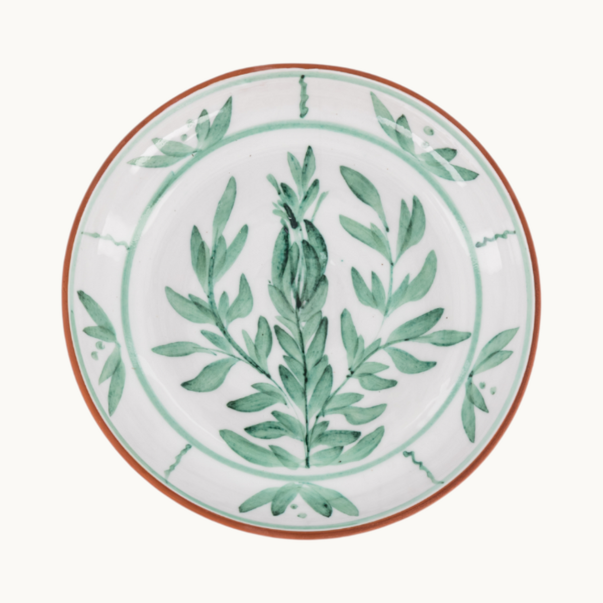 MANTRA LIVING Lebrillo platter with white glazed interior, green botanical hand-painted motifs, and terracotta rim.