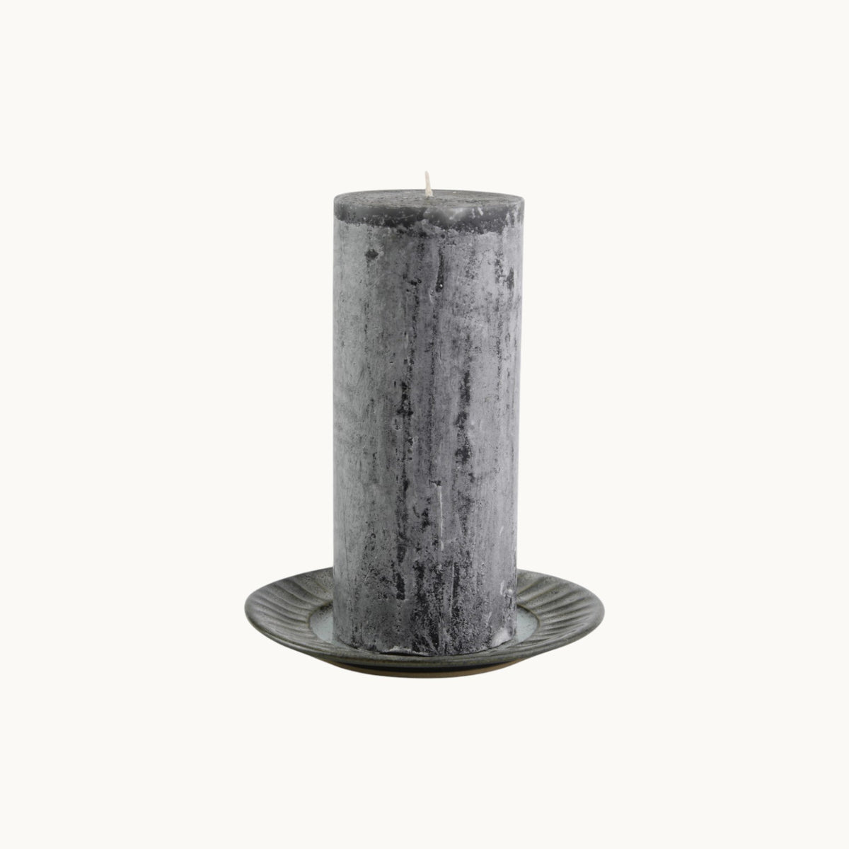MANTRA LIVING charcoal frosted pillar candle with a textured wax finish on a small decorative plate #Color_Charcoal