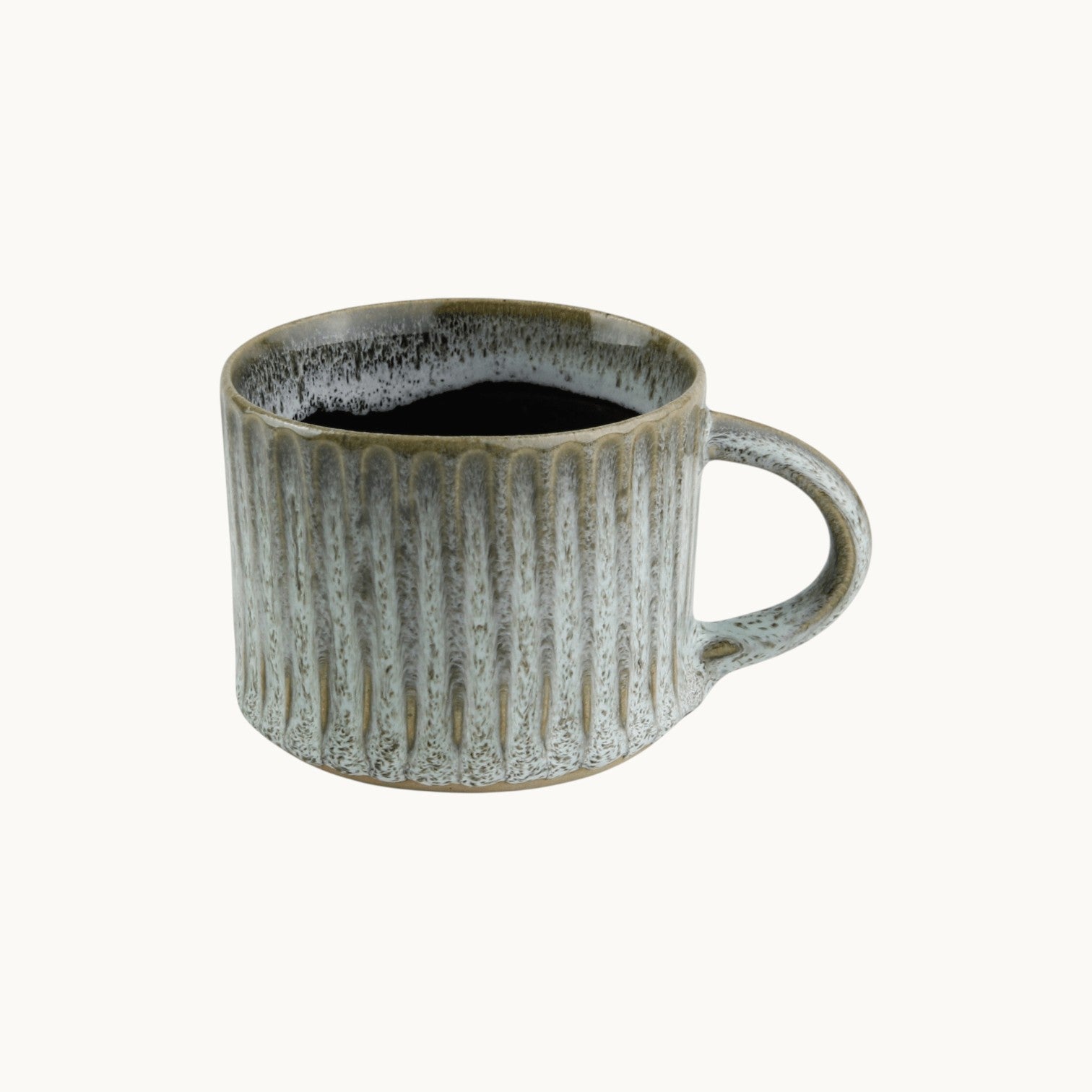 MANTRA LIVING wheel-thrown fluted mug in a speckled antique slate glaze with a textured finish.