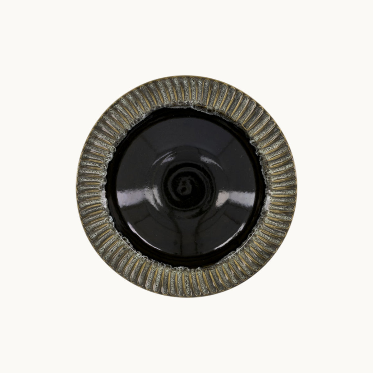 MANTRA LIVING handcrafted ceramic centerpiece bowl with a glossy black interior and textured fluted rim
