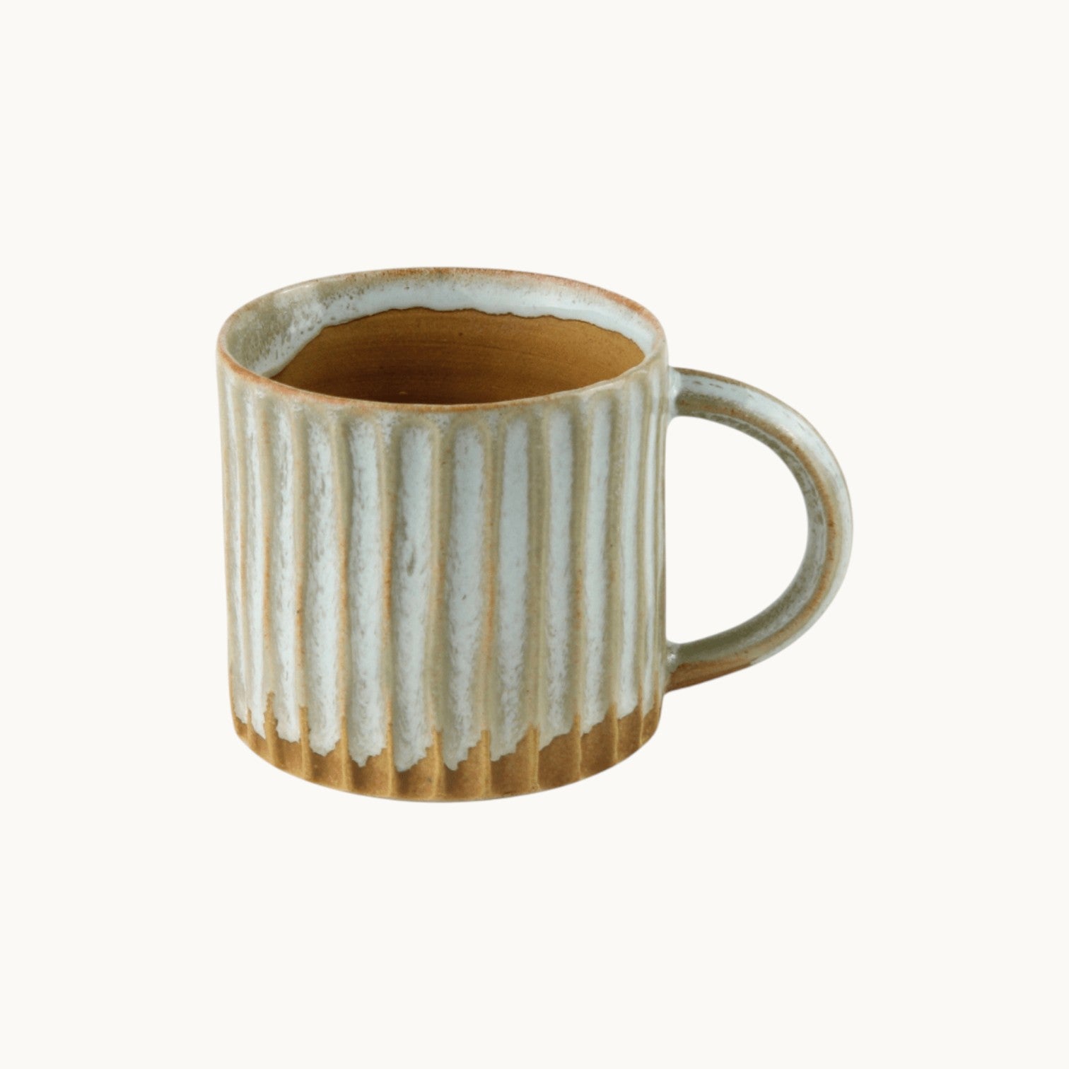 MANTRA LIVING wheel-thrown ceramic mug with fluted sides and a mottled desert oasis glaze finish.