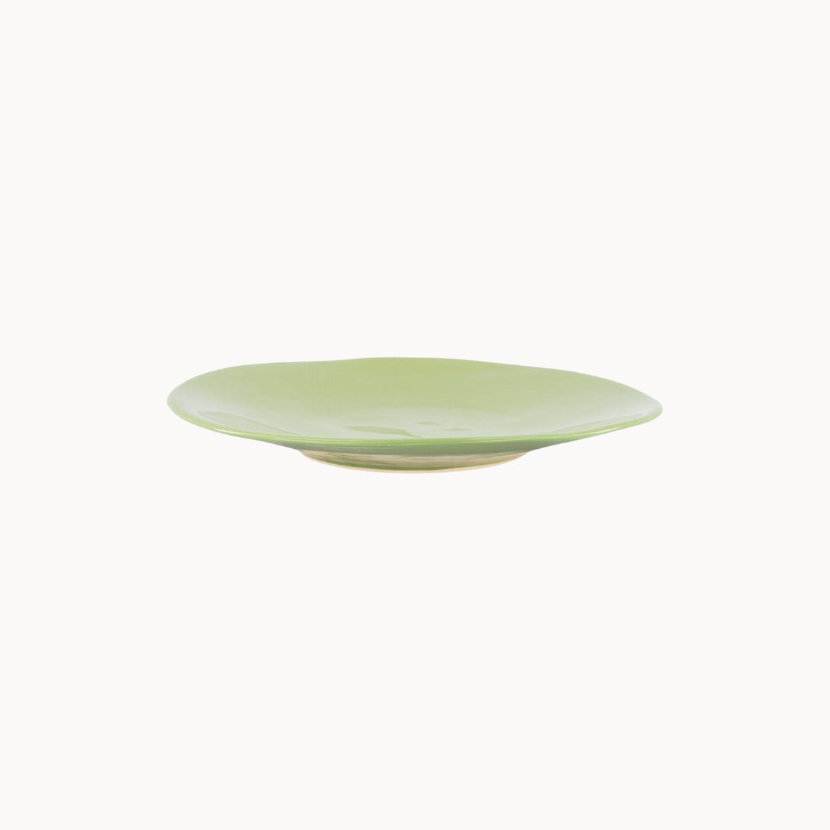 Mantra Living Classic Stoneware presentation plate in Green Tea, hand-finished by Mervyn Gers, seen in profile. #Color_Green Tea