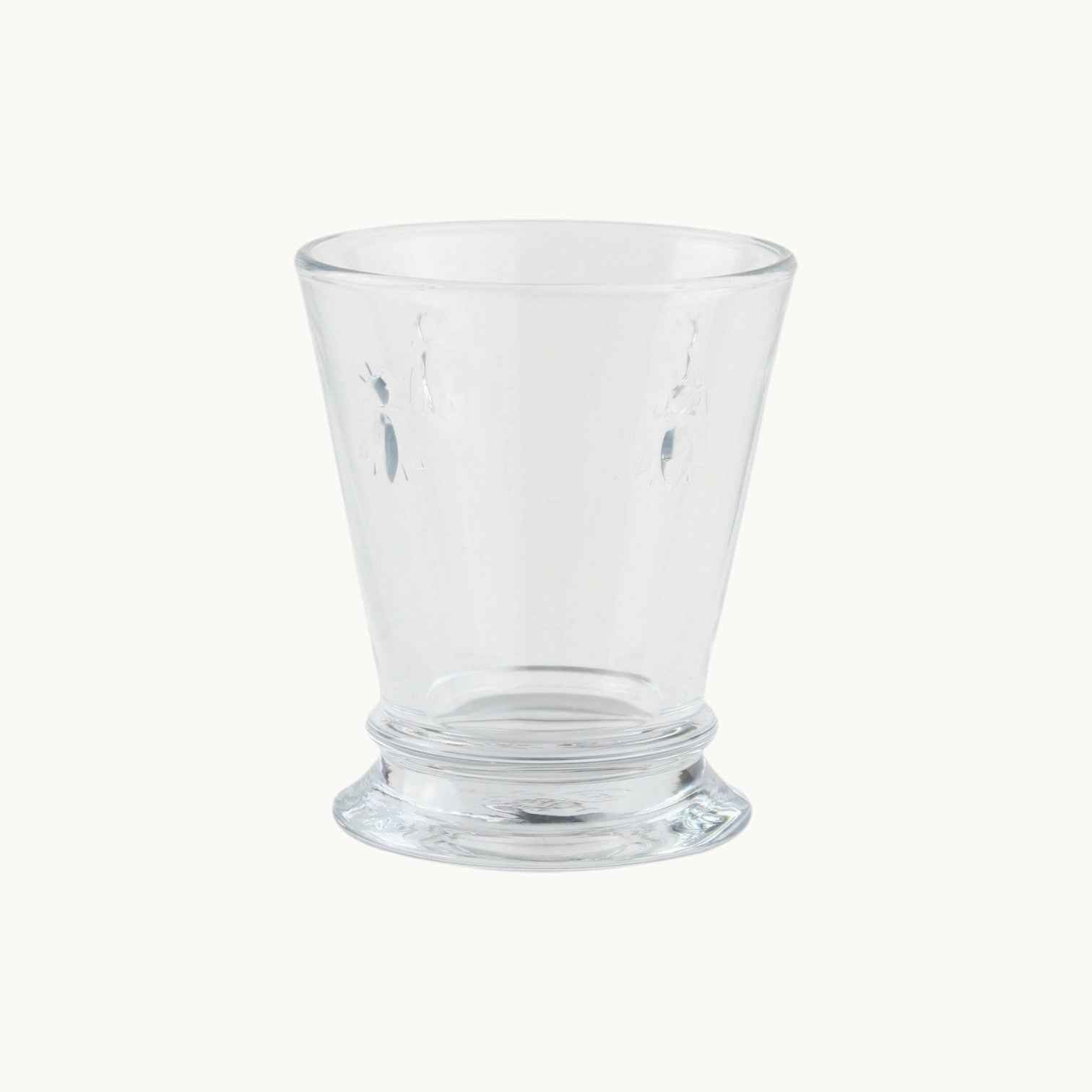 MANTRA LIVING La Rochère clear glass tumbler featuring an embossed bee motif in a classic French design.