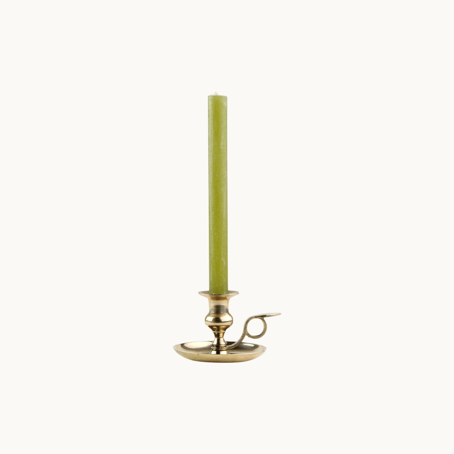 Mantra Living Frosted Dinner Candle in olive, a soft green taper in a brass chamberstick holder. #Color_Olive