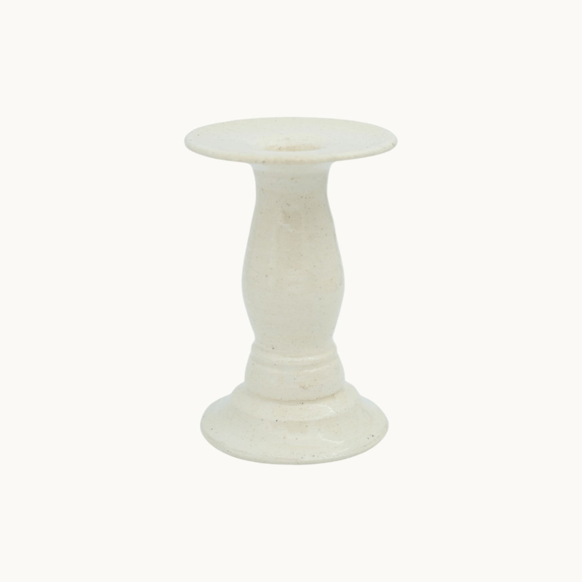 The Siena candlestick holder in cream Panna ceramic, extra short 10cm size, with a squat pedestal base and wide dish top. #Color_Panna