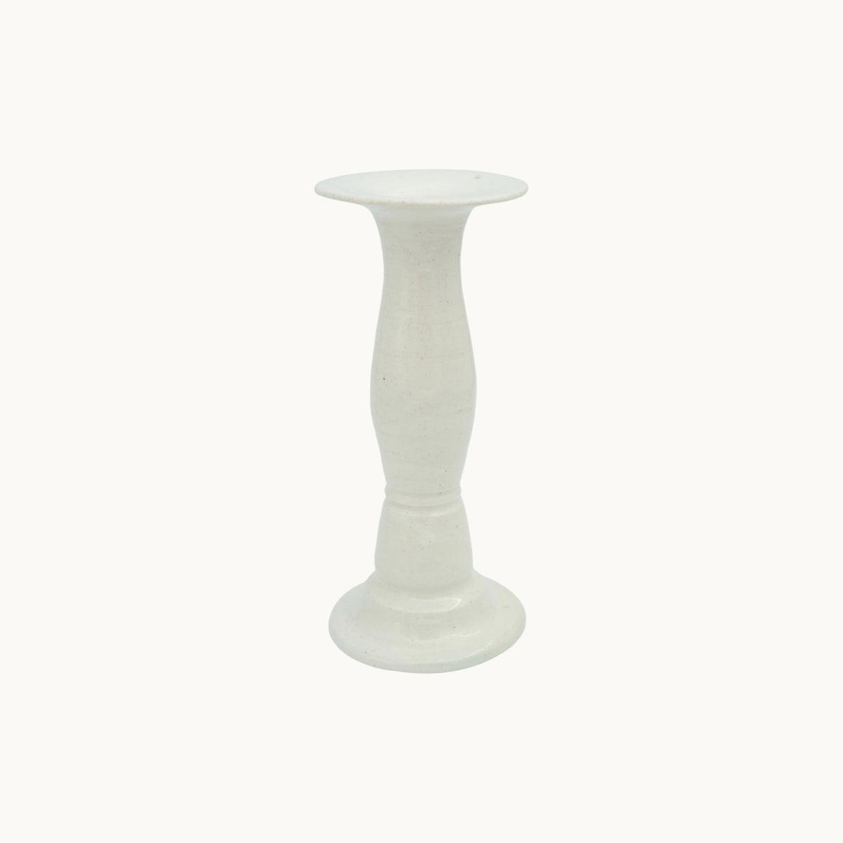 The Siena candlestick holder in cream Panna ceramic, medium 19cm size, with a turned pedestal stem and wide dish top. #Color_Panna