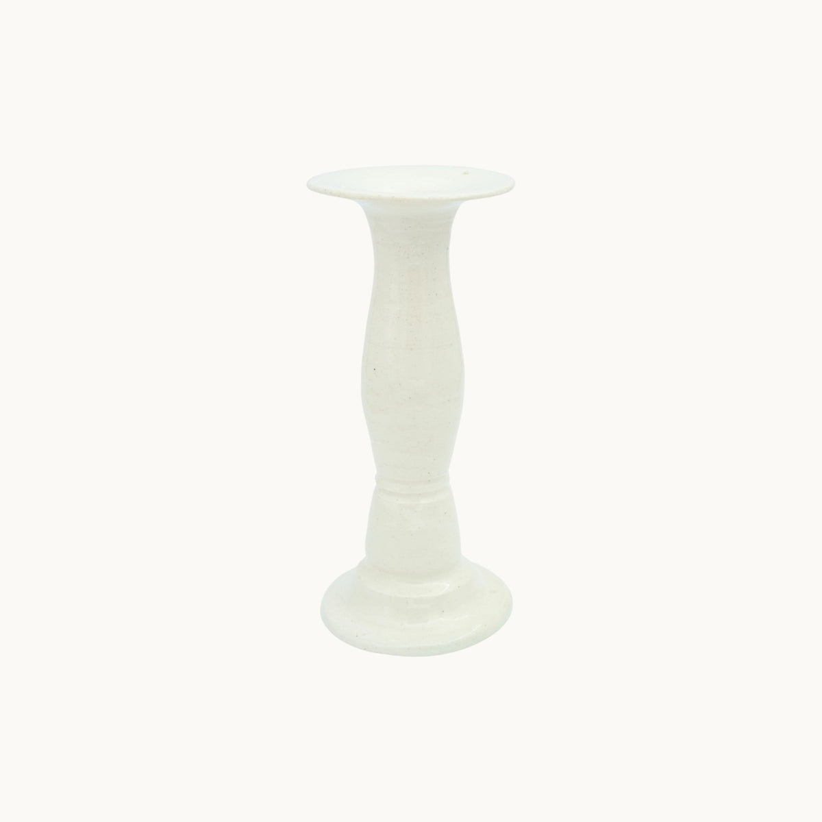 The Siena candlestick holder in cream Panna ceramic, tall 23cm size, with a turned pedestal stem and wide dish top. #Color_Panna
