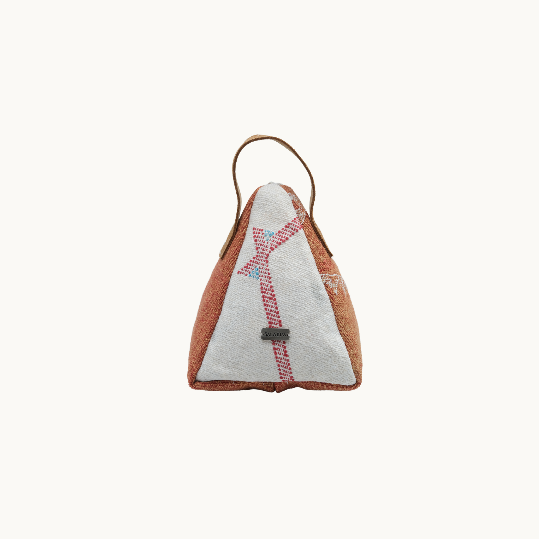 Cream Moroccan silk Salabim door stop with terracotta corners and a pink woven cross motif, front view #color_Cream and Terracotta