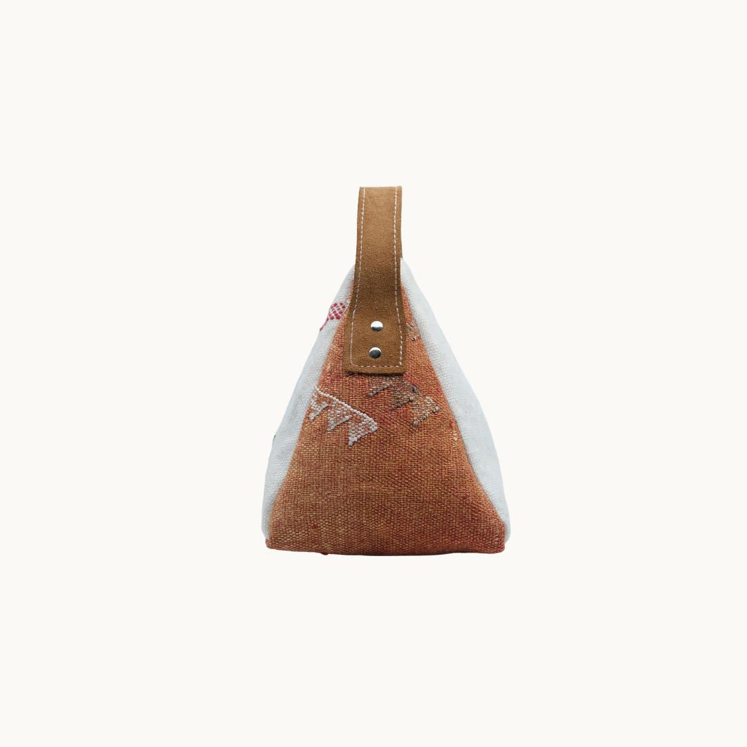 Cream and terracotta Moroccan silk Salabim door stop in side profile, showing the riveted tan leather carry loop #color_Cream and Terracotta