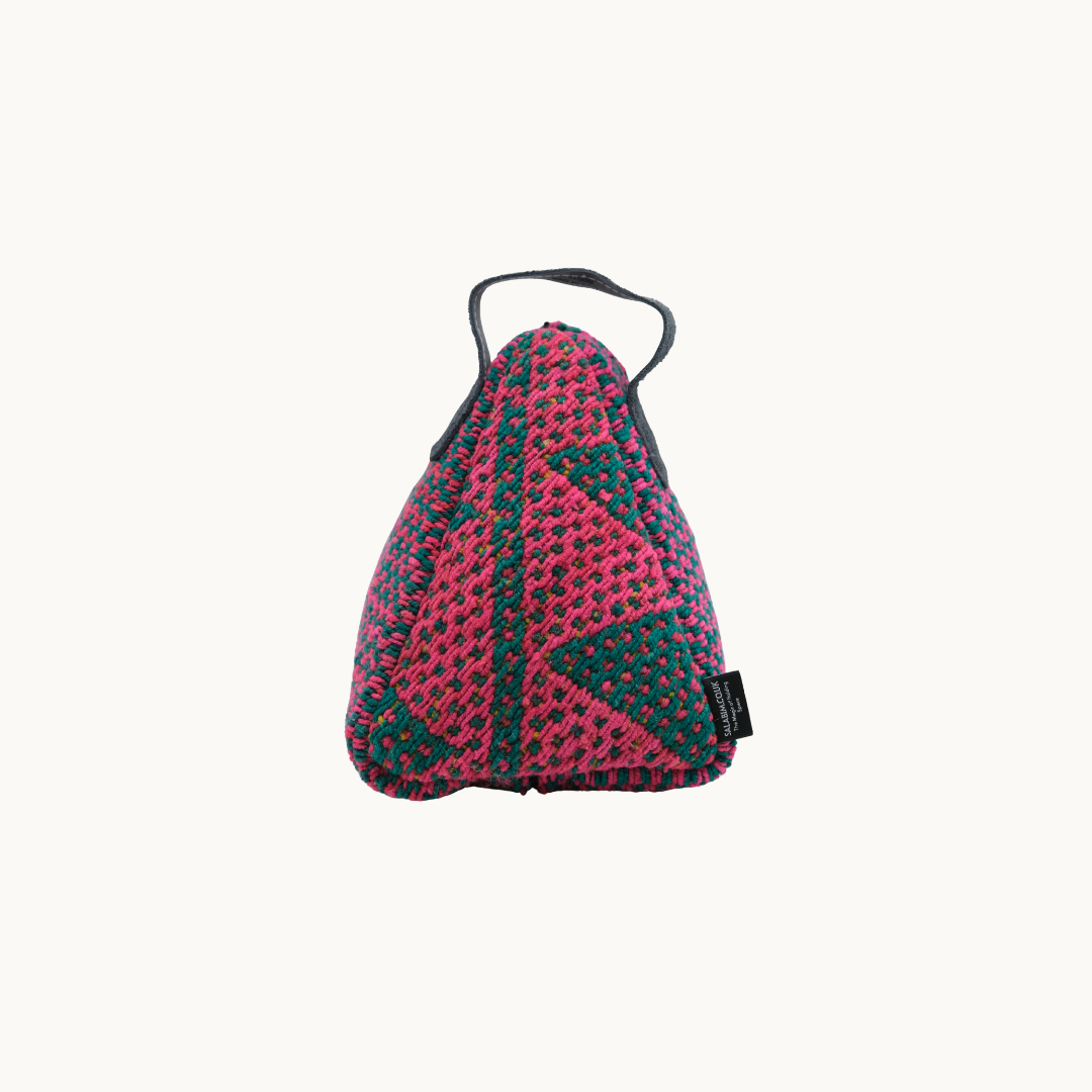 Magenta and teal Salabim weighted door stop from the reverse, showing the teal triangle motif and woven label #color_Magenta and Teal