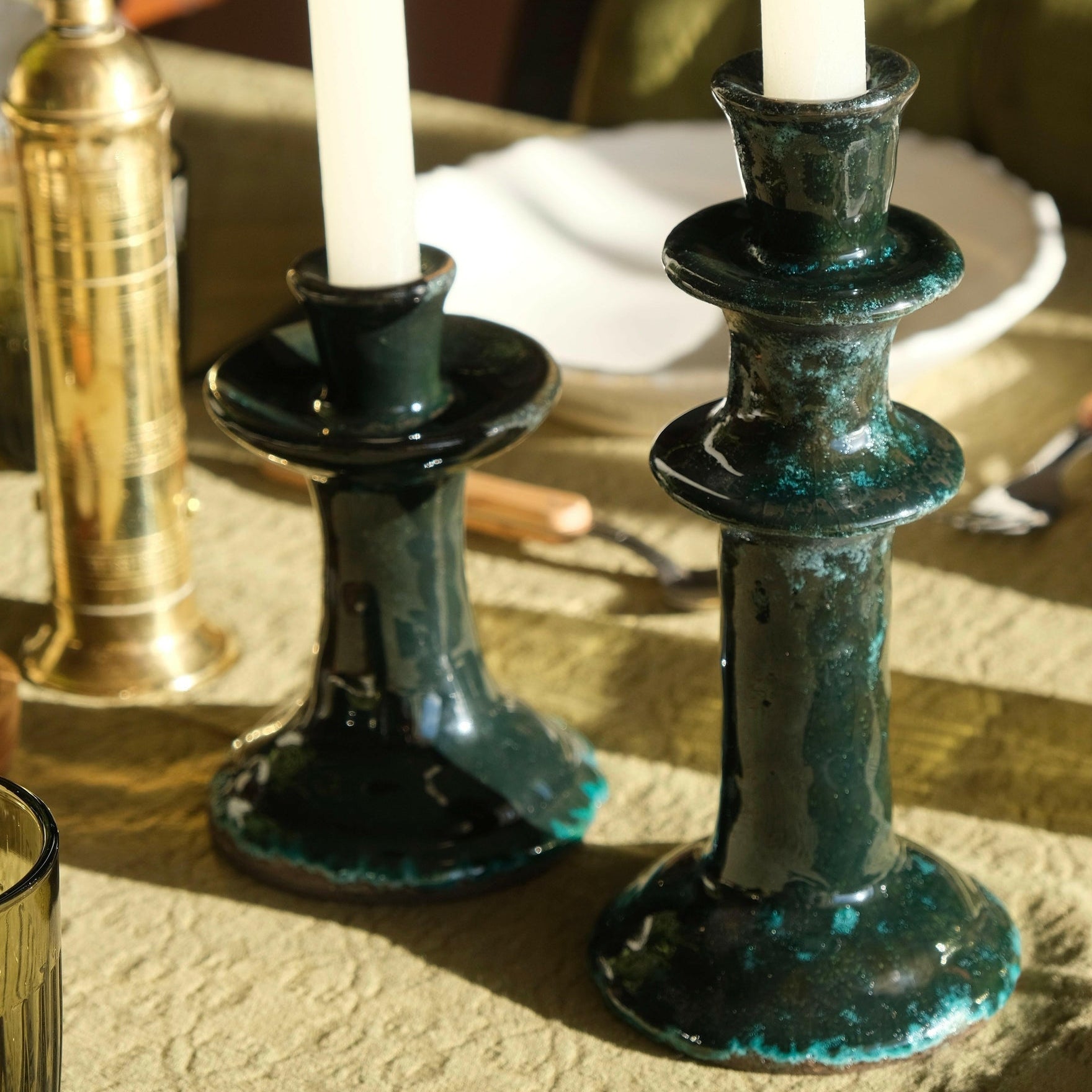 Mantra Living Tall Tiered Candle Holders in midnight, a pair on a set table with cream tapers and brass. #Color_Midnight