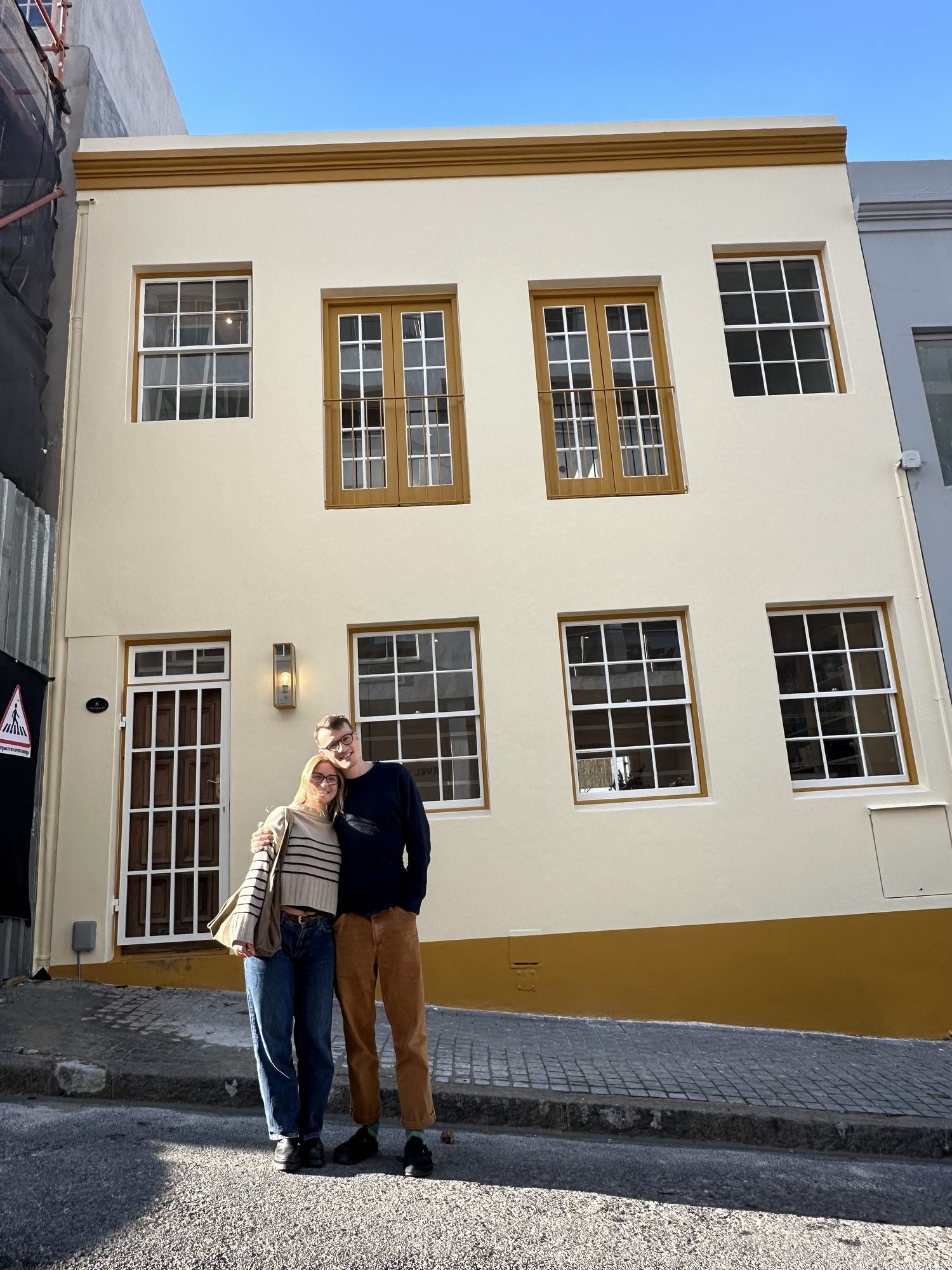 The Mantra Living shopfront at 8 Watson Street, a cream building with mustard window frames