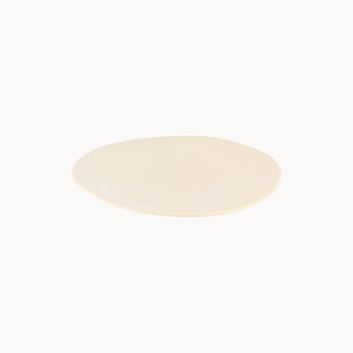 Mantra Living Classic Stoneware presentation plate in Almond, a warm neutral glaze with an organic hand-finished edge. #Color_Almond