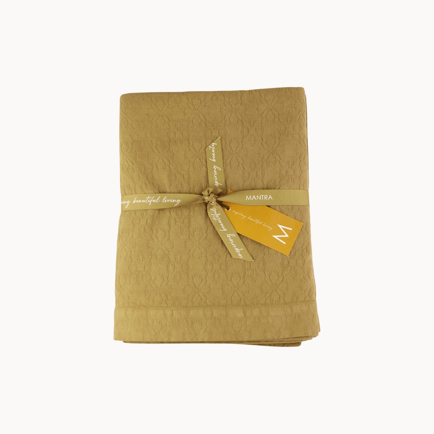 Mantra Living Hibiscus cotton tablecloth in butterscotch, jacquard-woven with a textured floral pattern. #Color_Butterscotch
