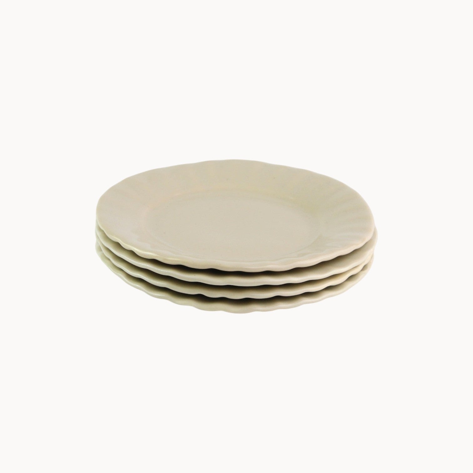 Mantra Living Daisy side plates in Almond, stacked to show the scalloped rim. #Color_Almond