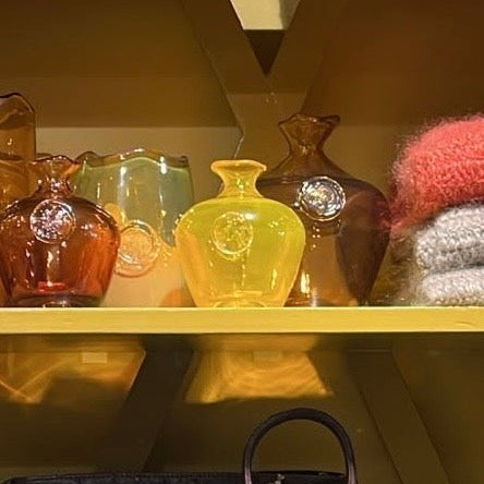 MANTRA LIVING Casa LV Emily mouth-blown glass vases in yellow and amber on a display shelf #color_yellow