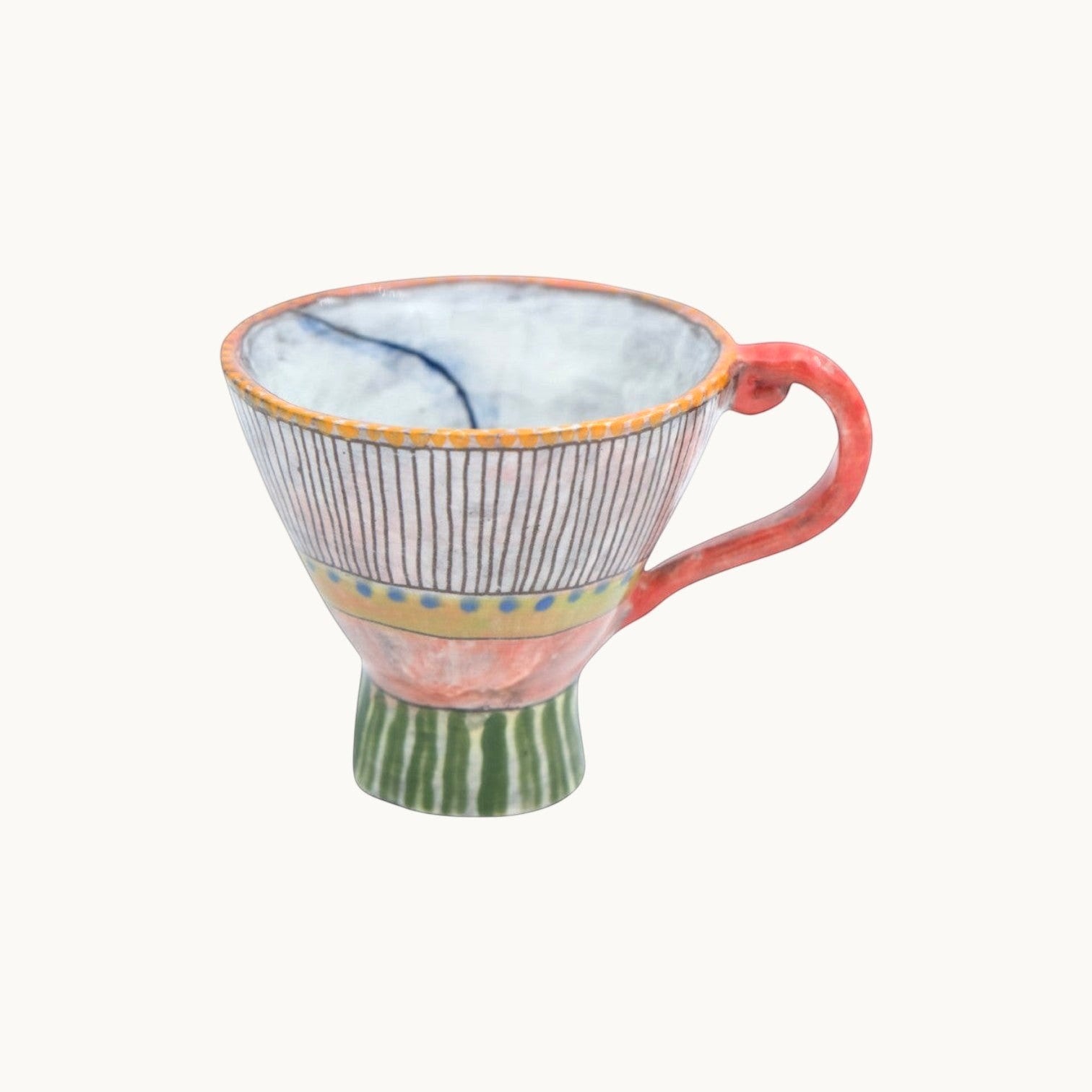 MANTRA LIVING Isabella tea cup with hand-painted pastel patterns, unique ceramic design, and a curved handle.