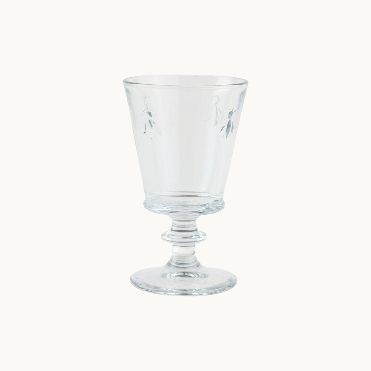 MANTRA LIVING La Rochère clear glass goblet featuring an embossed French bee motif on a pedestal base