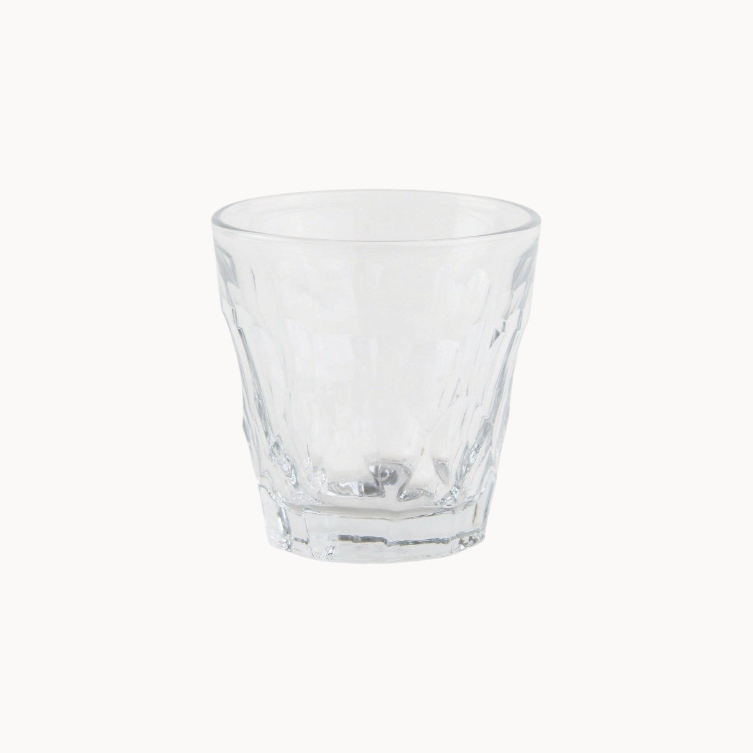 Mantra Living La Rochere Silex tumbler, clear pressed glass with a faceted, dimpled body and a heavy base, for water or spirits.