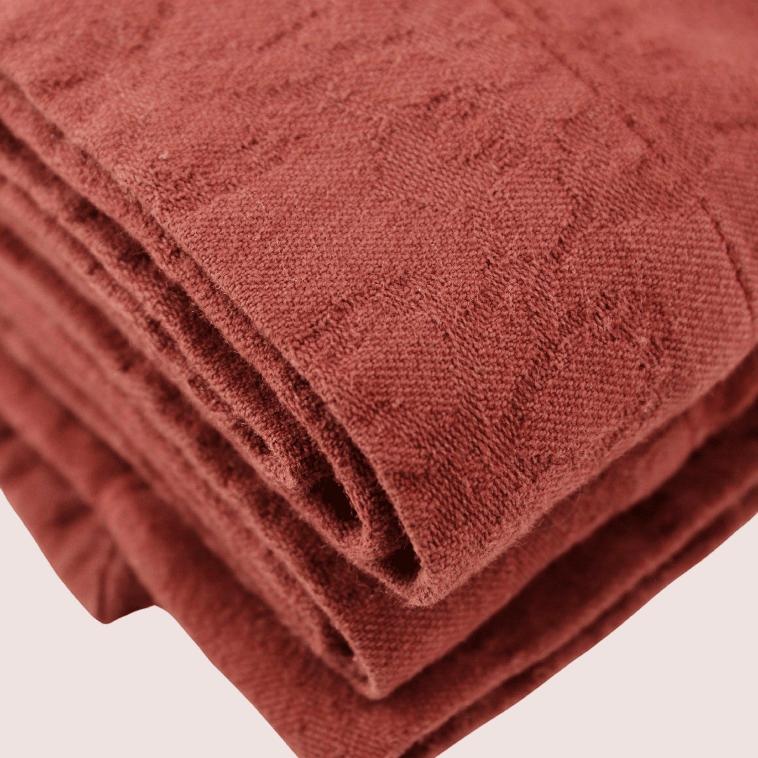 Mantra Living Hibiscus cotton tablecloth in maple red, jacquard-woven with intricate textured detail. #Color_Maple