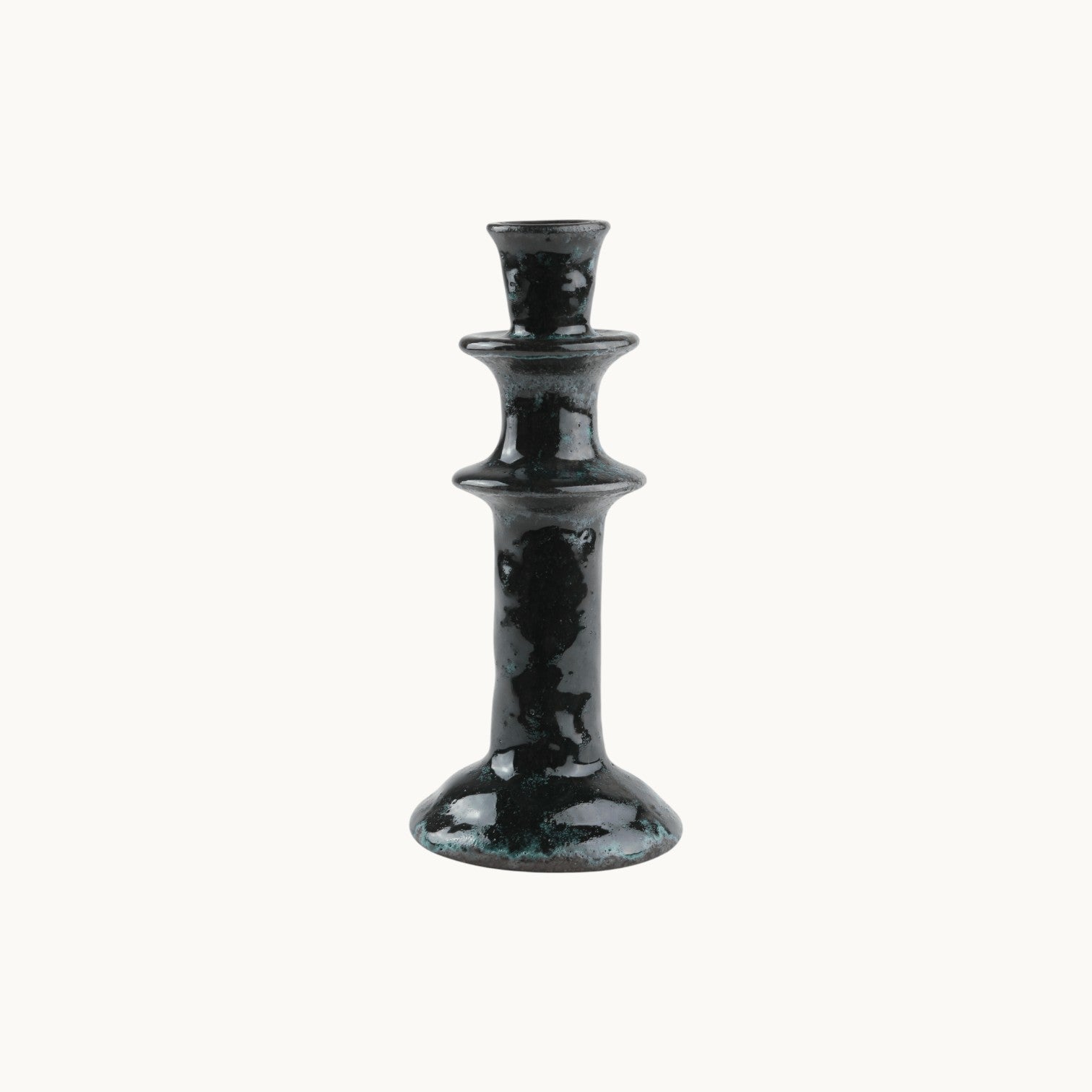 Mantra Living Tall Tiered Candle Holder in midnight, a glossy near-black glaze over the tiered stem. #Color_Midnight