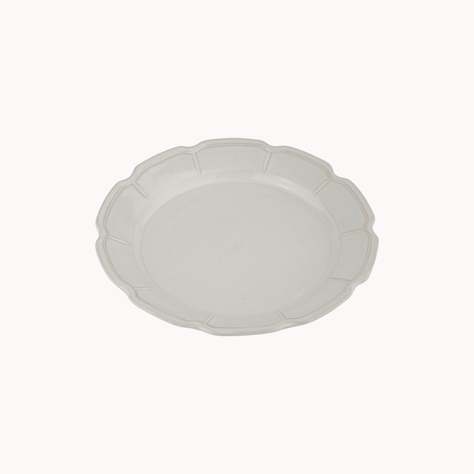 MANTRA LIVING Milkstone handmade ceramic plate with a soft milky glaze and elegant scalloped edge detail.
