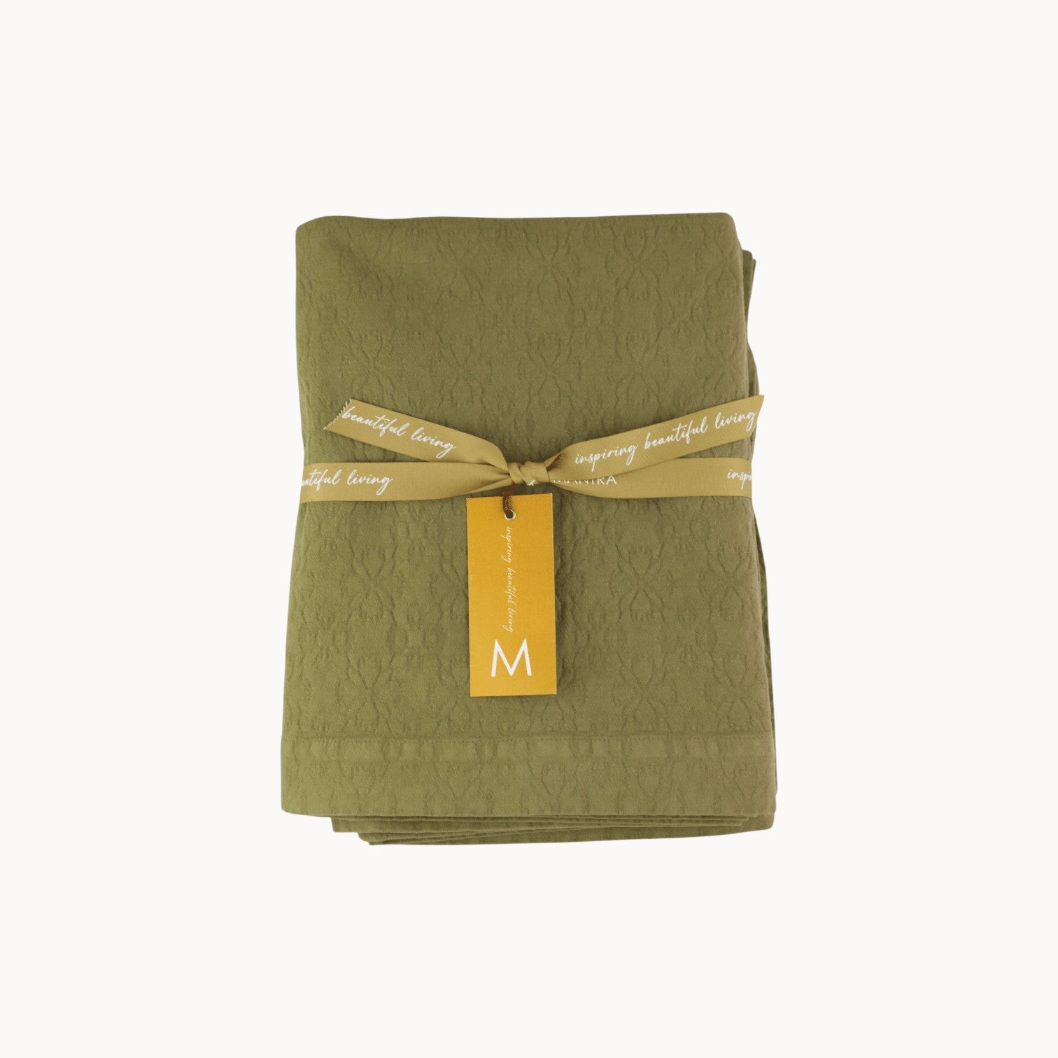Mantra Living Hibiscus cotton tablecloth in pistachio green, jacquard-woven with a hibiscus pattern and ribbon packaging. #Color_Pistachio