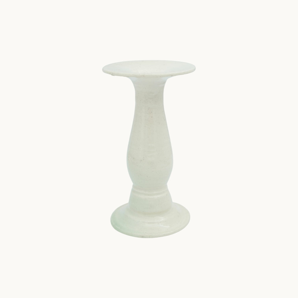 The Siena candlestick holder in cream Panna ceramic, short 14.5cm size, with a turned pedestal stem and wide dish top. #Color_Panna