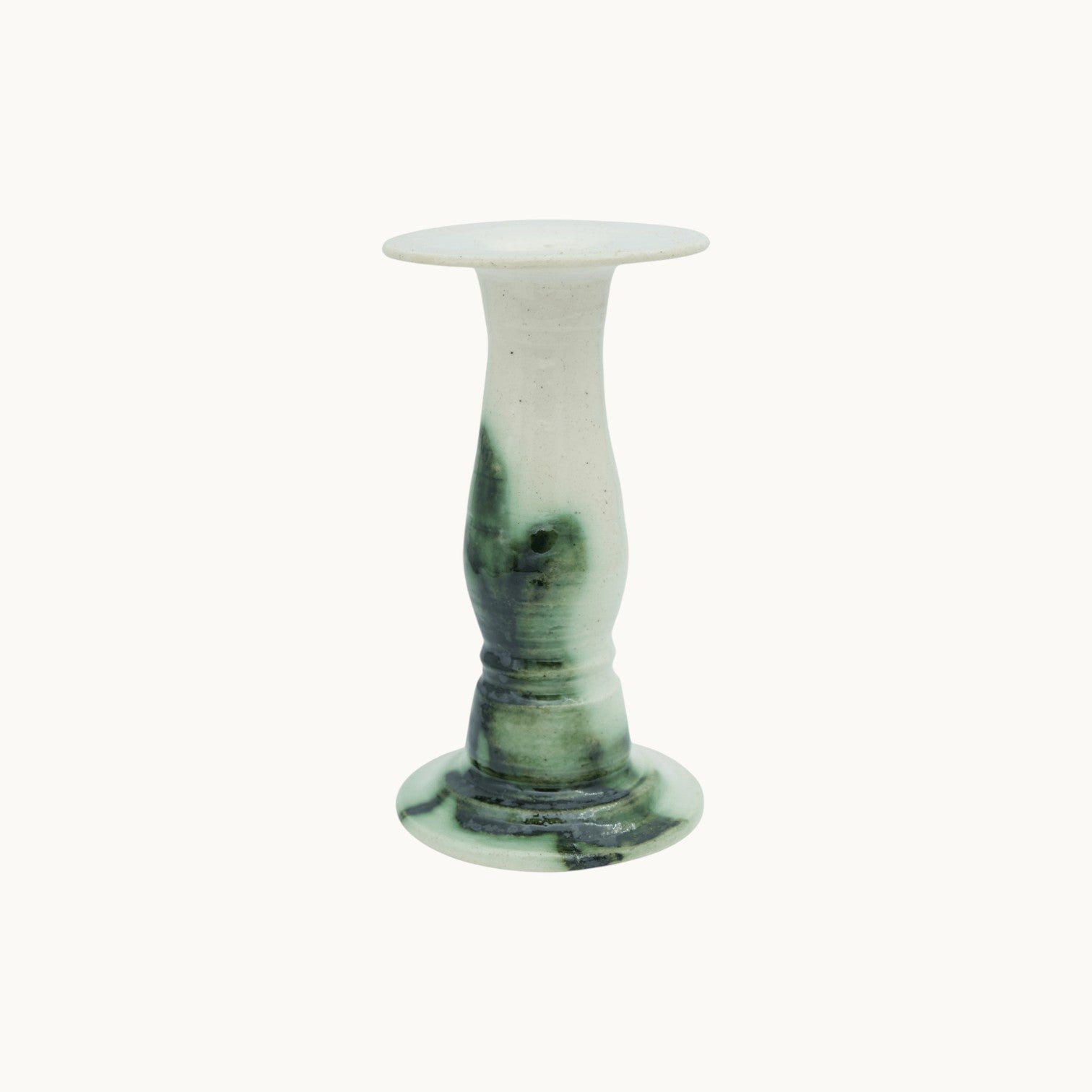 The Siena candlestick holder in Verde, cream ceramic with dark green marbled glaze, medium 19cm size on a turned pedestal stem. #Color_Verde