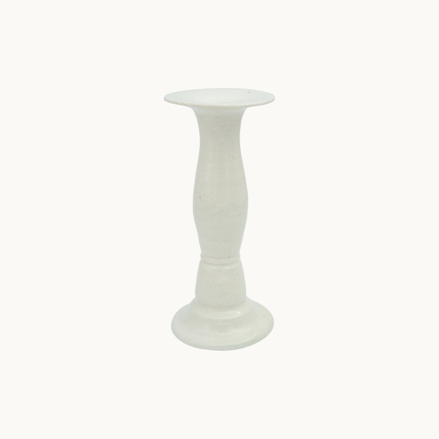 The Siena candlestick holder in cream Panna ceramic, medium 19cm size, with a turned pedestal stem and wide dish top. #Color_Panna