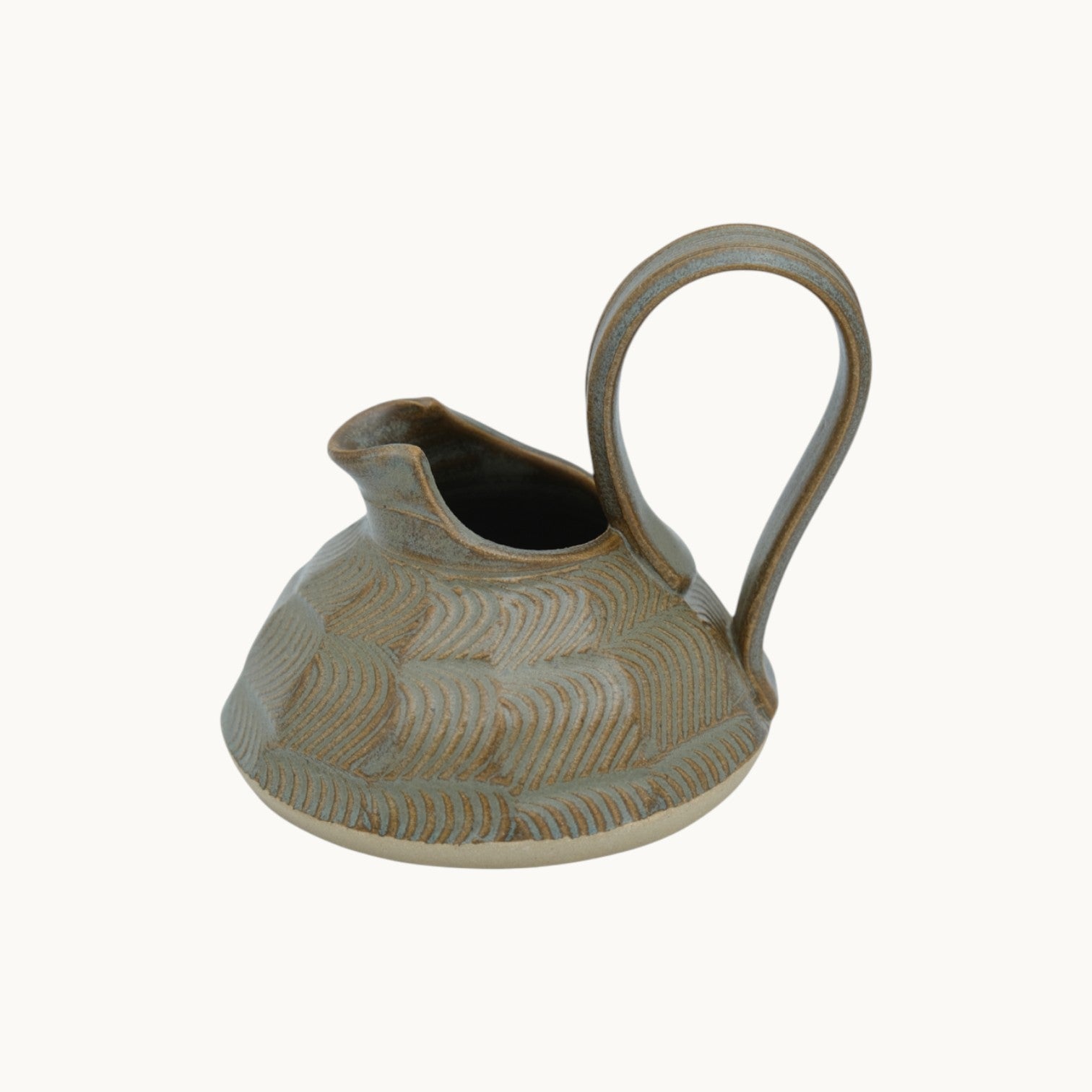 Mantra Living Small Ripple Jug in hand-thrown ceramic, with a carved rippled body and a generous loop handle.